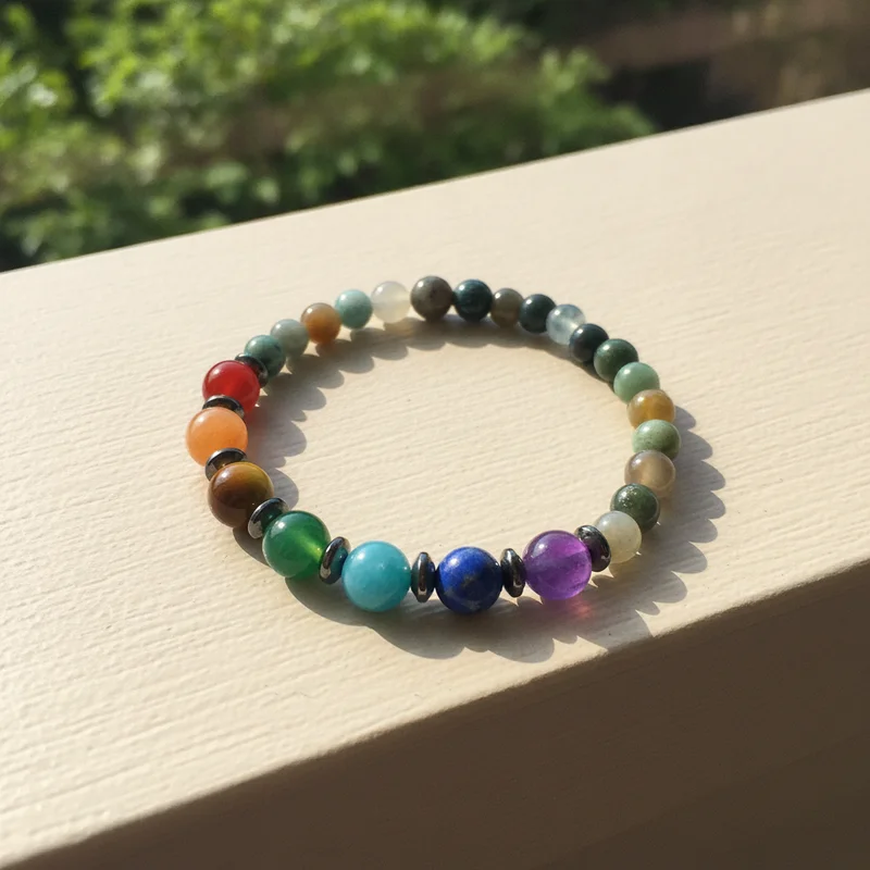 Bracelet 7 chakras posé près d'une fenêtre