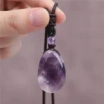 amethyste-main-1 Goutte d'améthyste tenue entre les doigts
