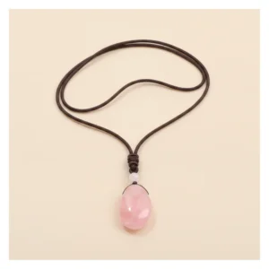 Pendentif quartz rose posé à plat sur fond clair